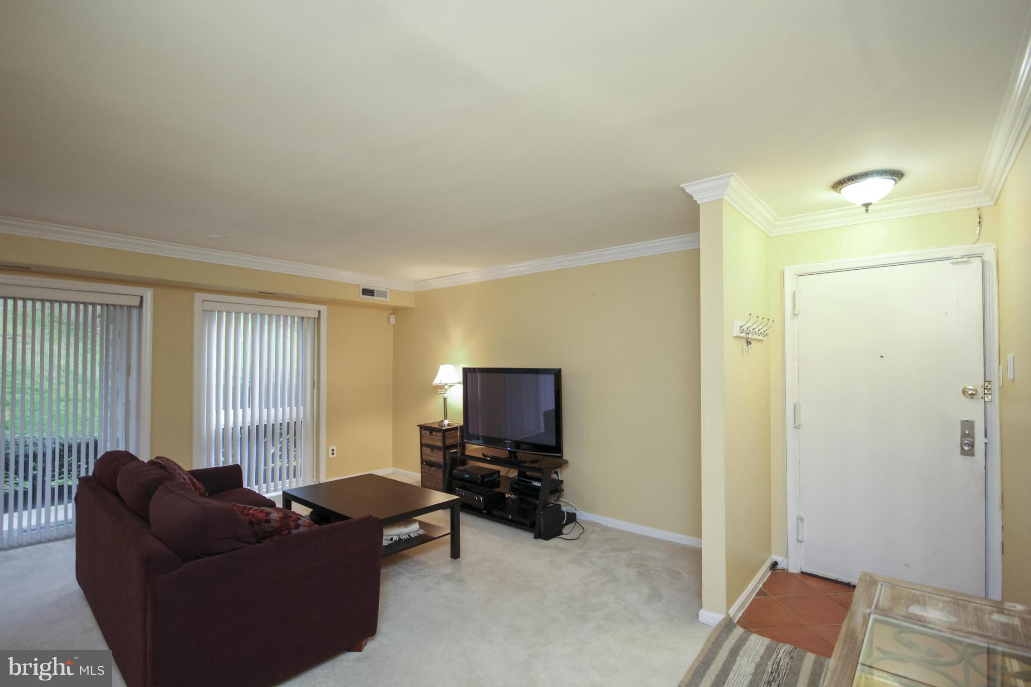 6155 Edsall Road, Unit 6155 Alexandria, VA 22304 - Photo 7 of 29 a living room with furniture and a flat screen tv