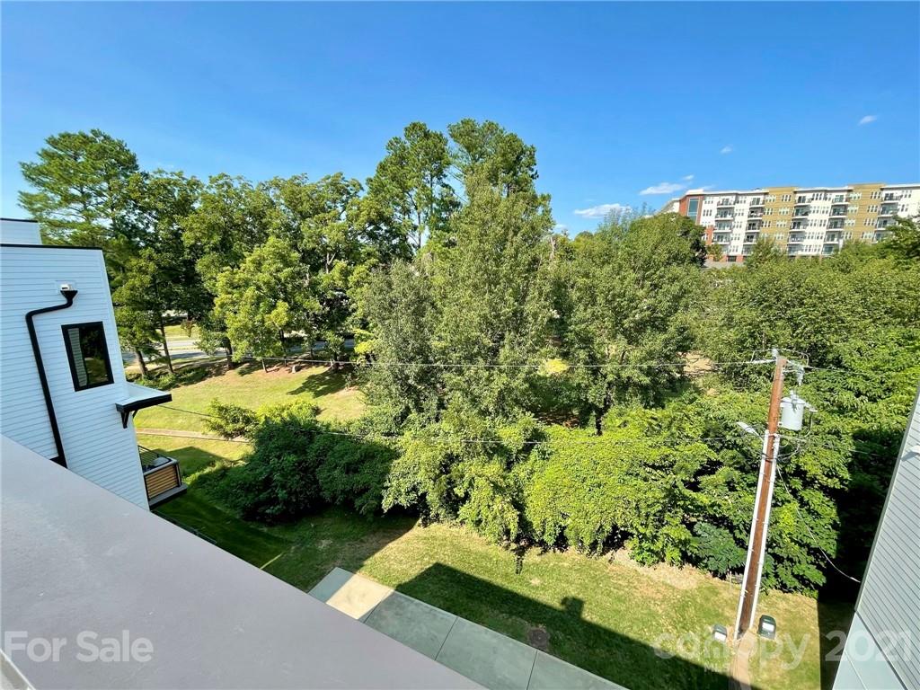 936 Westbrook Drive, Unit A Charlotte, NC 28202 - Photo 26 of 32 a view of a garden with a bench in a garden