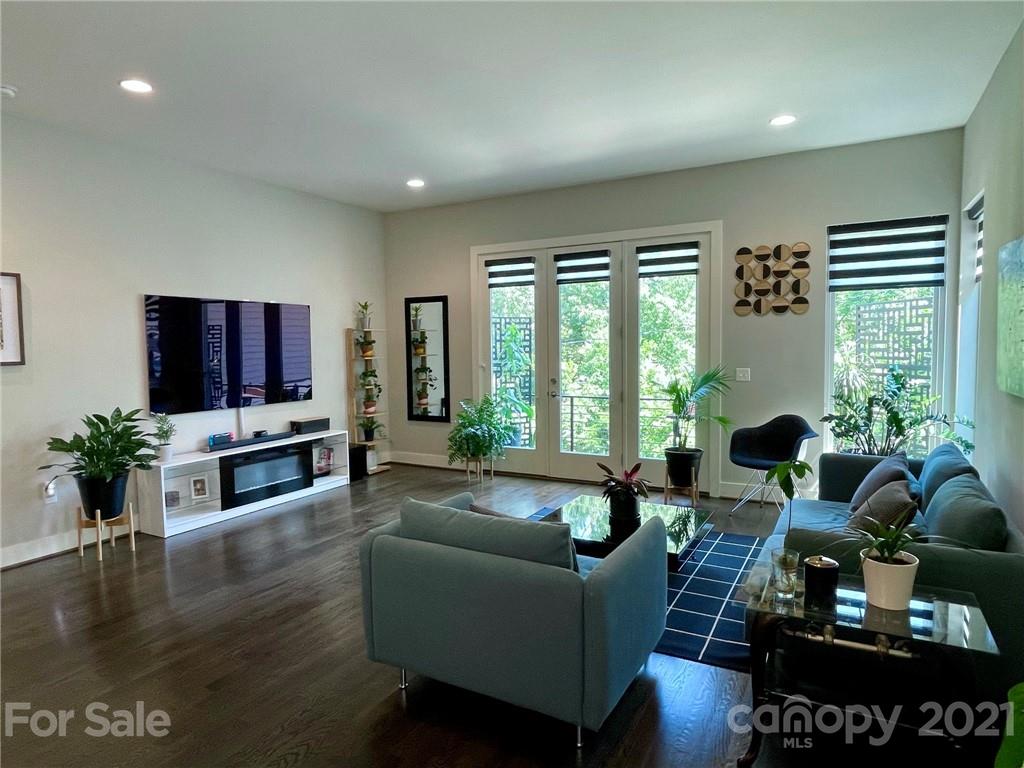 936 Westbrook Drive, Unit A Charlotte, NC 28202 - Photo 3 of 32 a living room with furniture tv and a large window