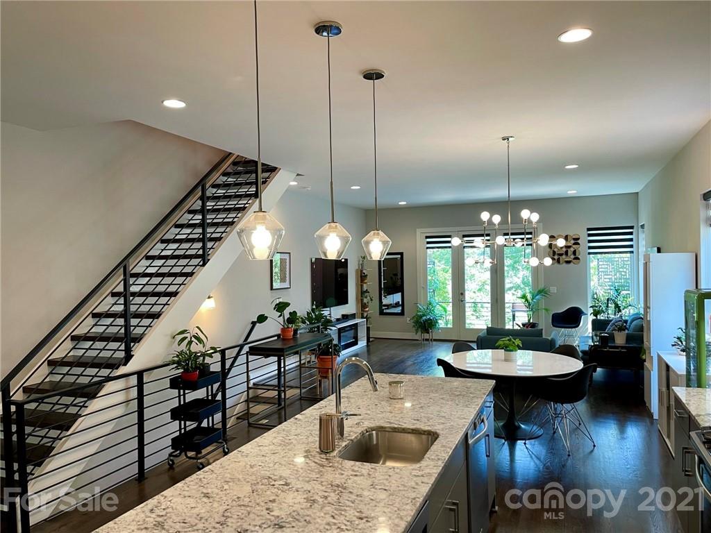 936 Westbrook Drive, Unit A Charlotte, NC 28202 - Photo 5 of 32 a kitchen with a table and chairs