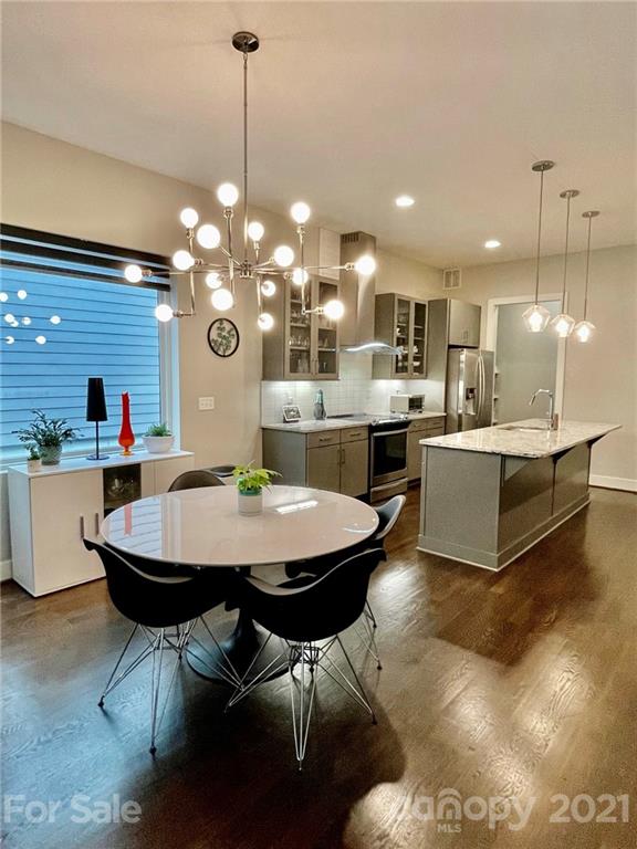 936 Westbrook Drive, Unit A Charlotte, NC 28202 - Photo 7 of 32 a view of a dining room with furniture and wooden floor