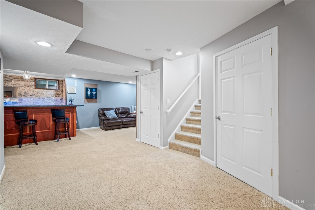 55 Janney Lane Springboro, OH 45066 - Photo 31 of 38 This versatile basement space features a built-in bar and convenient access to stairs.
