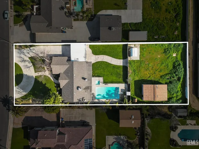 an aerial view of houses with a yard