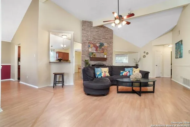 a living room with fireplace furniture and a wooden floor