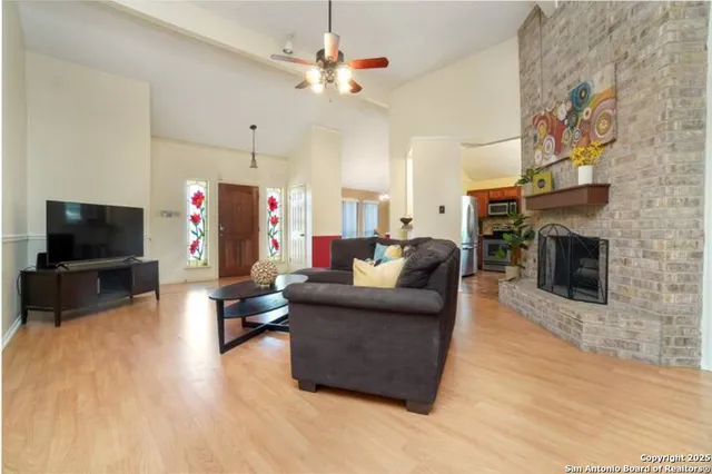 a living room with furniture a flat screen tv and a fireplace