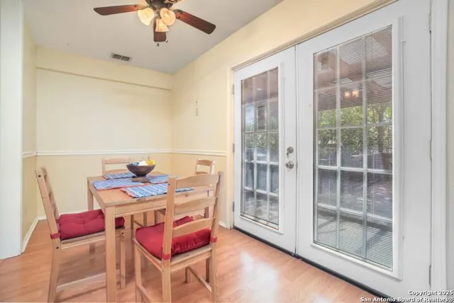a living room with furniture a chandelier and a floor to ceiling window