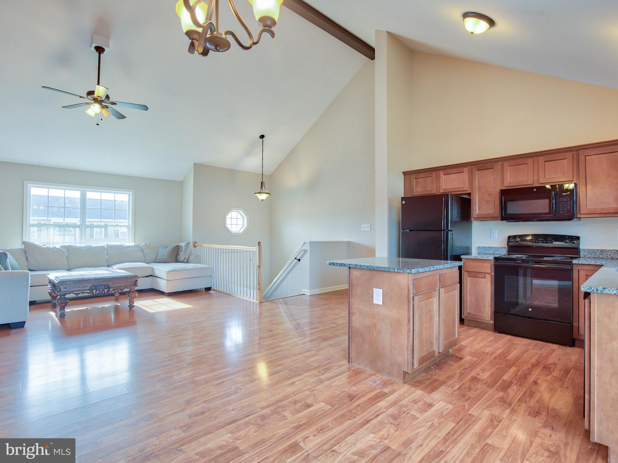 125 Job Road Inwood, WV 25428 - Photo 32 of 32 Open floorplan with vaulted ceiling and beam
