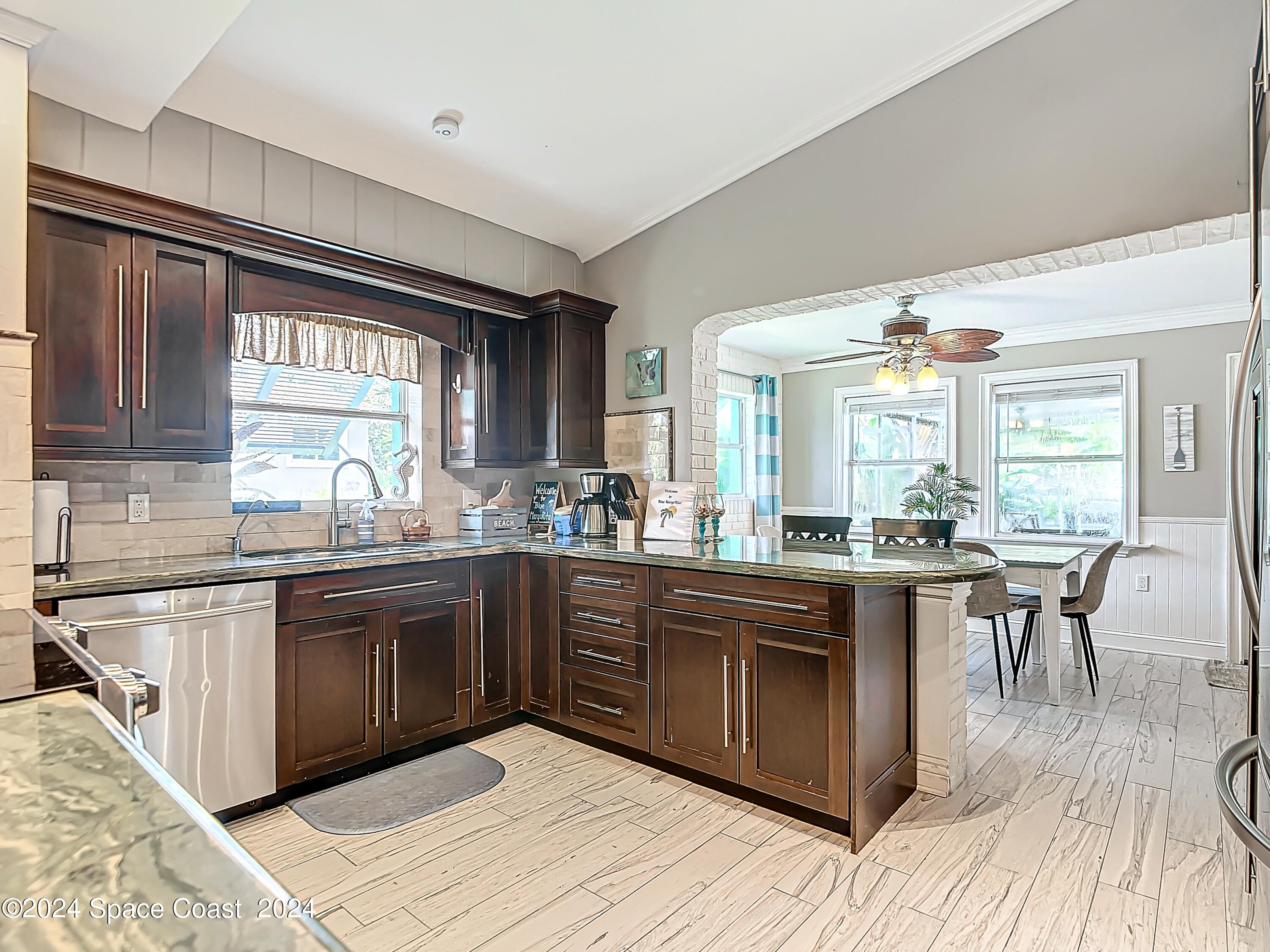 230 Rita Boulevard Melbourne Beach, FL 32951 - Photo 13 of 36 a kitchen with stainless steel appliances granite countertop a stove and cabinets