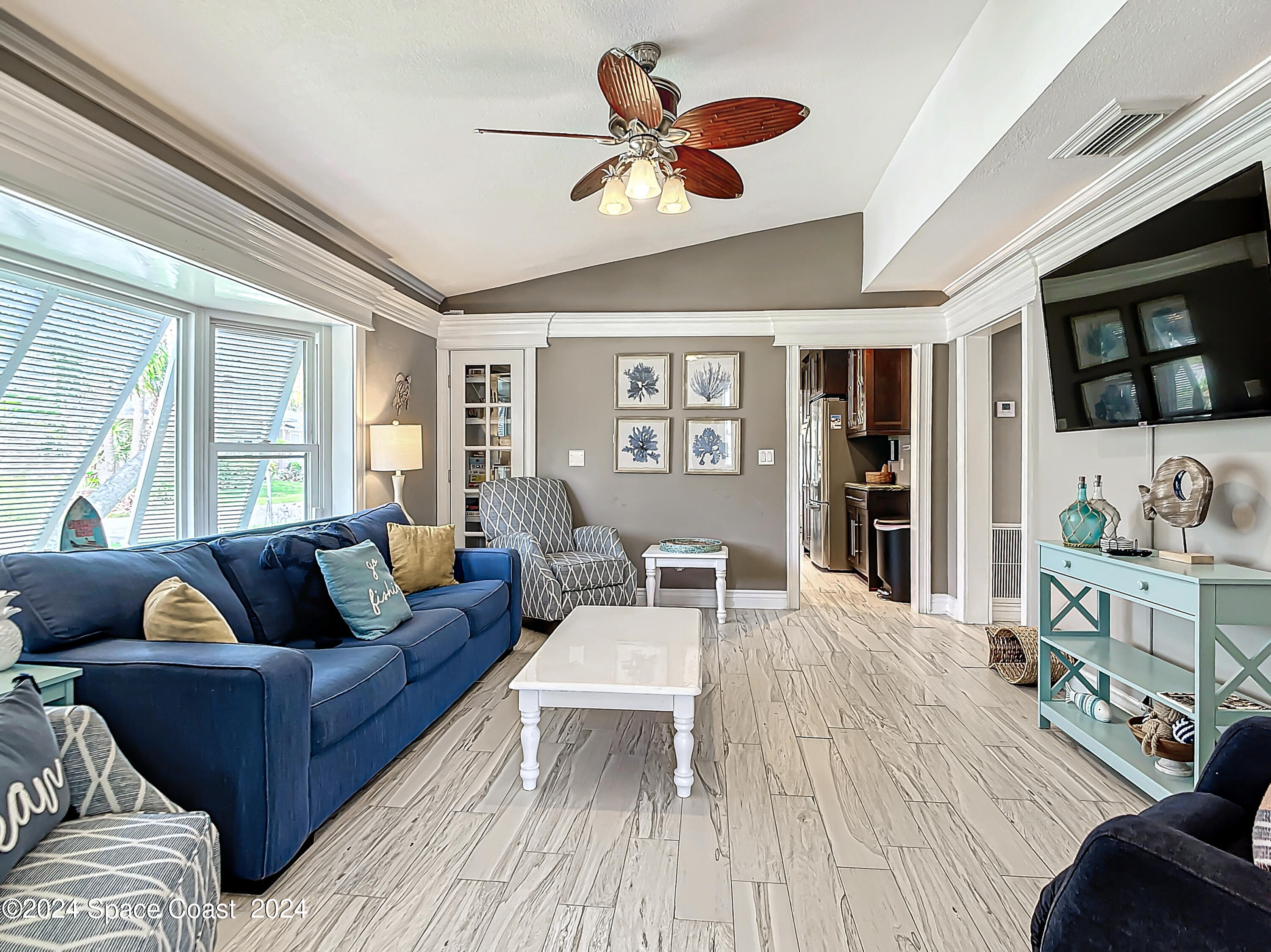 230 Rita Boulevard Melbourne Beach, FL 32951 - Photo 16 of 36 a living room with furniture and wooden floor