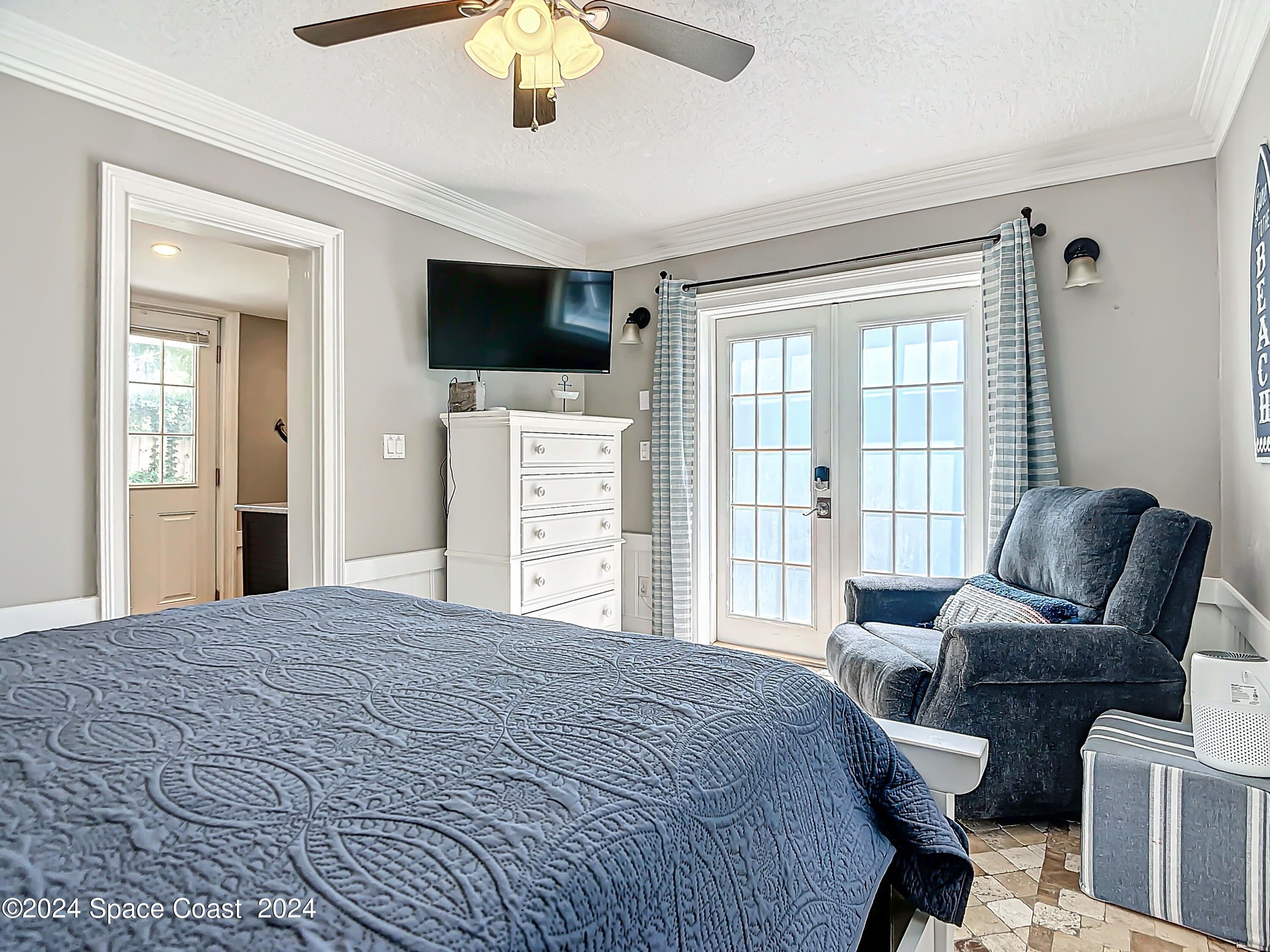 230 Rita Boulevard Melbourne Beach, FL 32951 - Photo 19 of 36 a bedroom with a bed and a flat screen tv