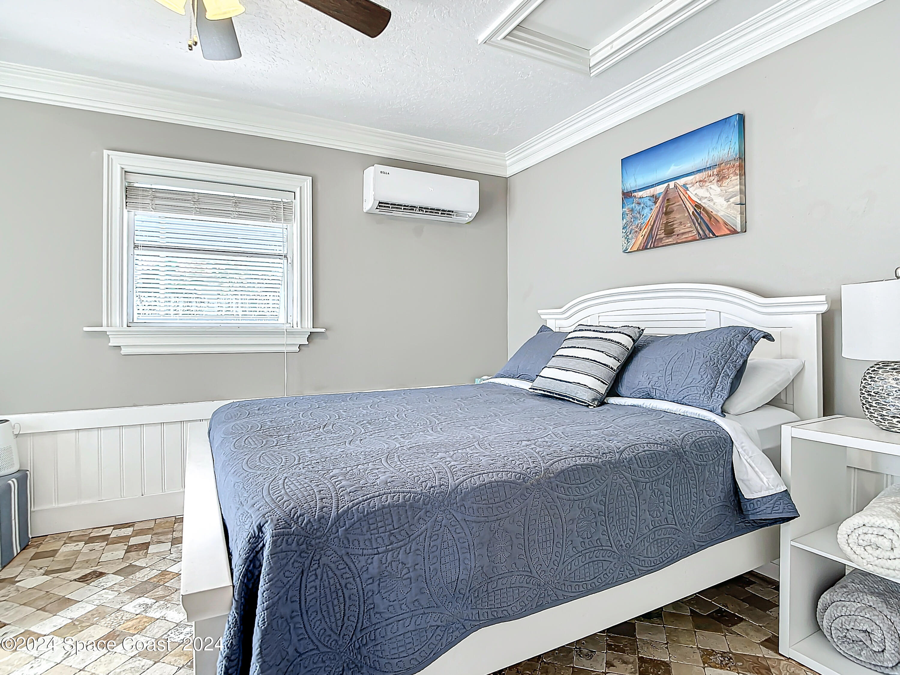 230 Rita Boulevard Melbourne Beach, FL 32951 - Photo 21 of 36 a bedroom with a bed a painting on the wall and a window