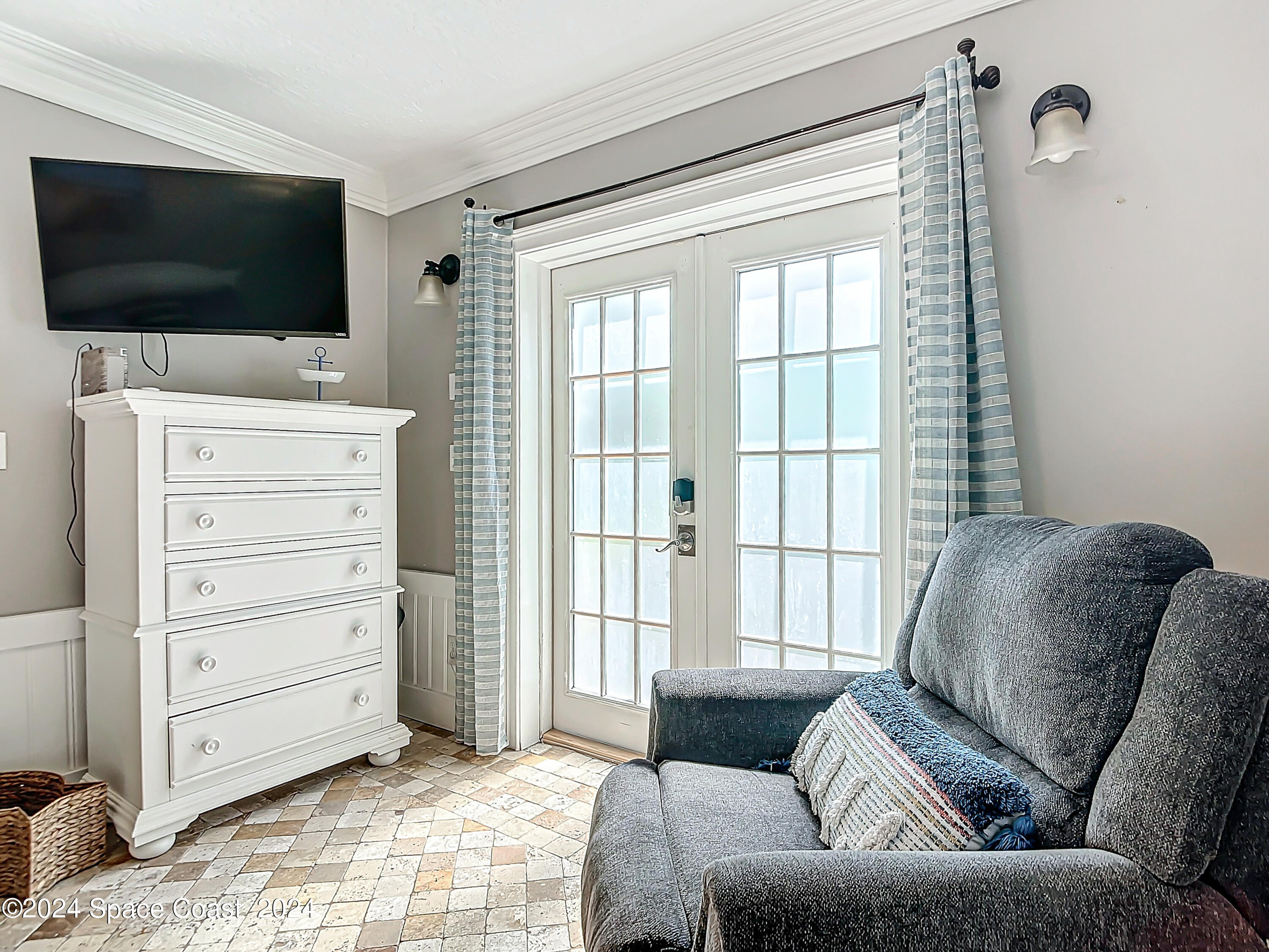 230 Rita Boulevard Melbourne Beach, FL 32951 - Photo 22 of 36 a living room with furniture and a flat screen tv