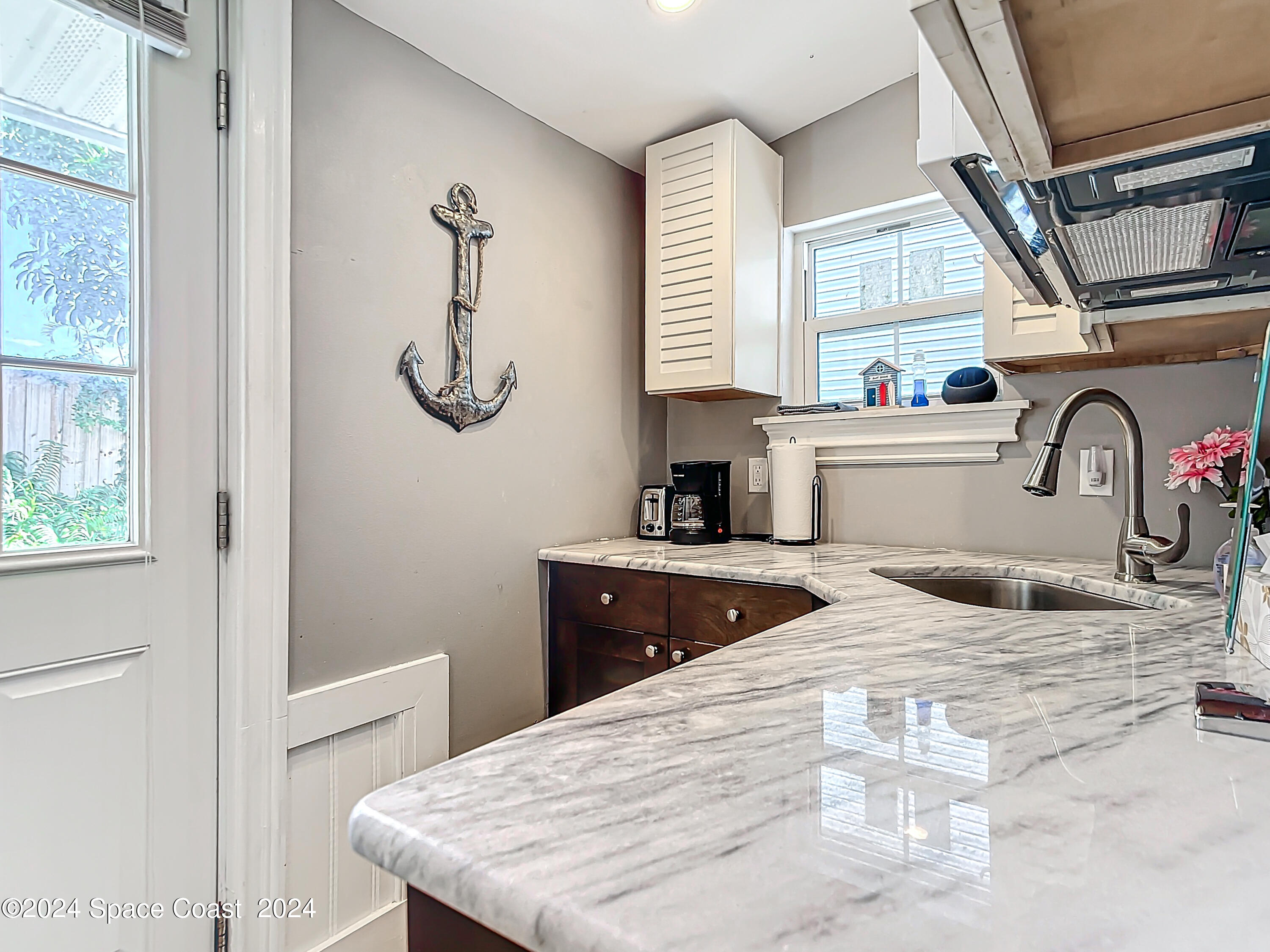 230 Rita Boulevard Melbourne Beach, FL 32951 - Photo 23 of 36 a bedroom with a bed and a dresser