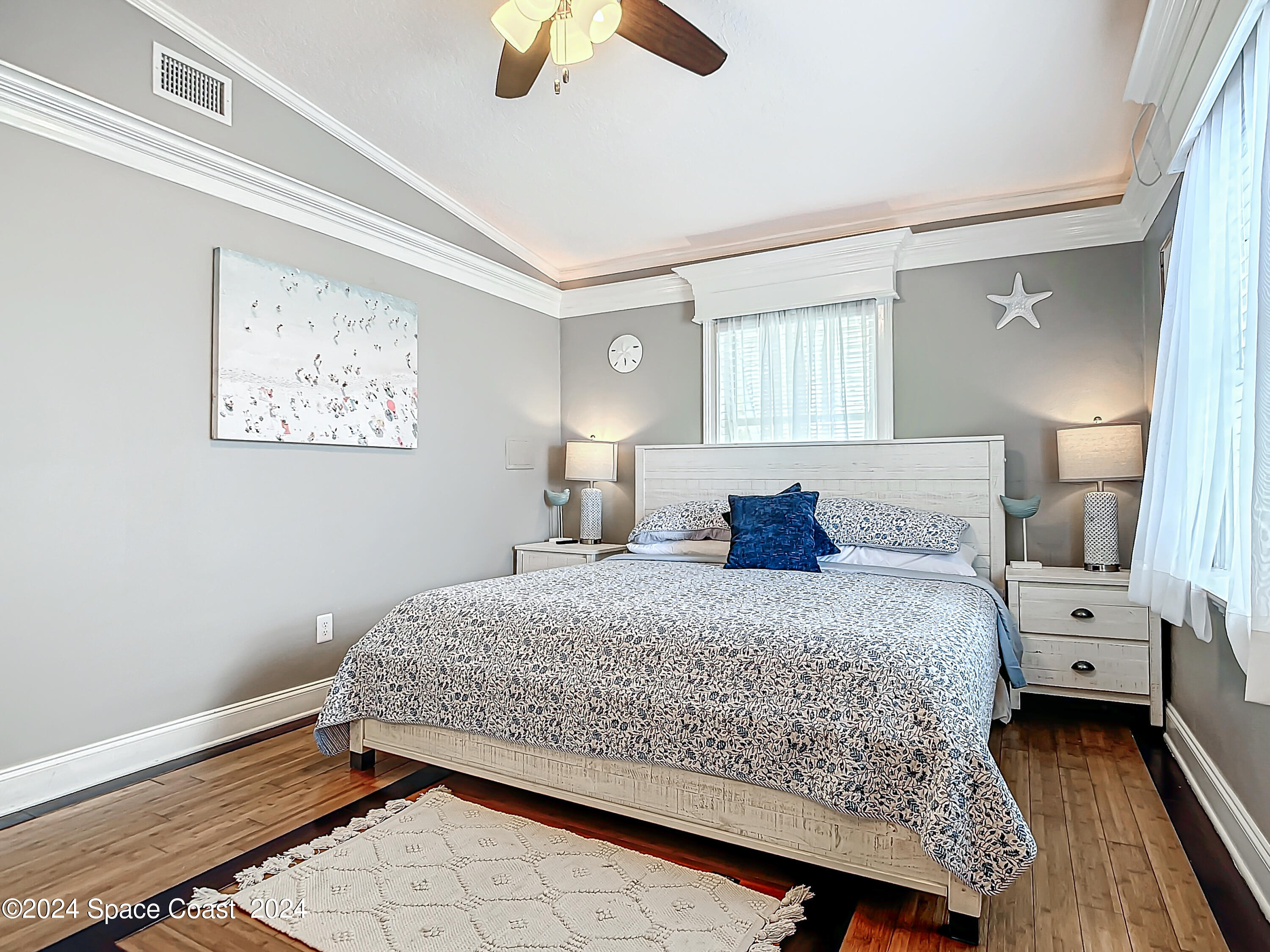 230 Rita Boulevard Melbourne Beach, FL 32951 - Photo 29 of 36 a bedroom with a bed and wooden floor