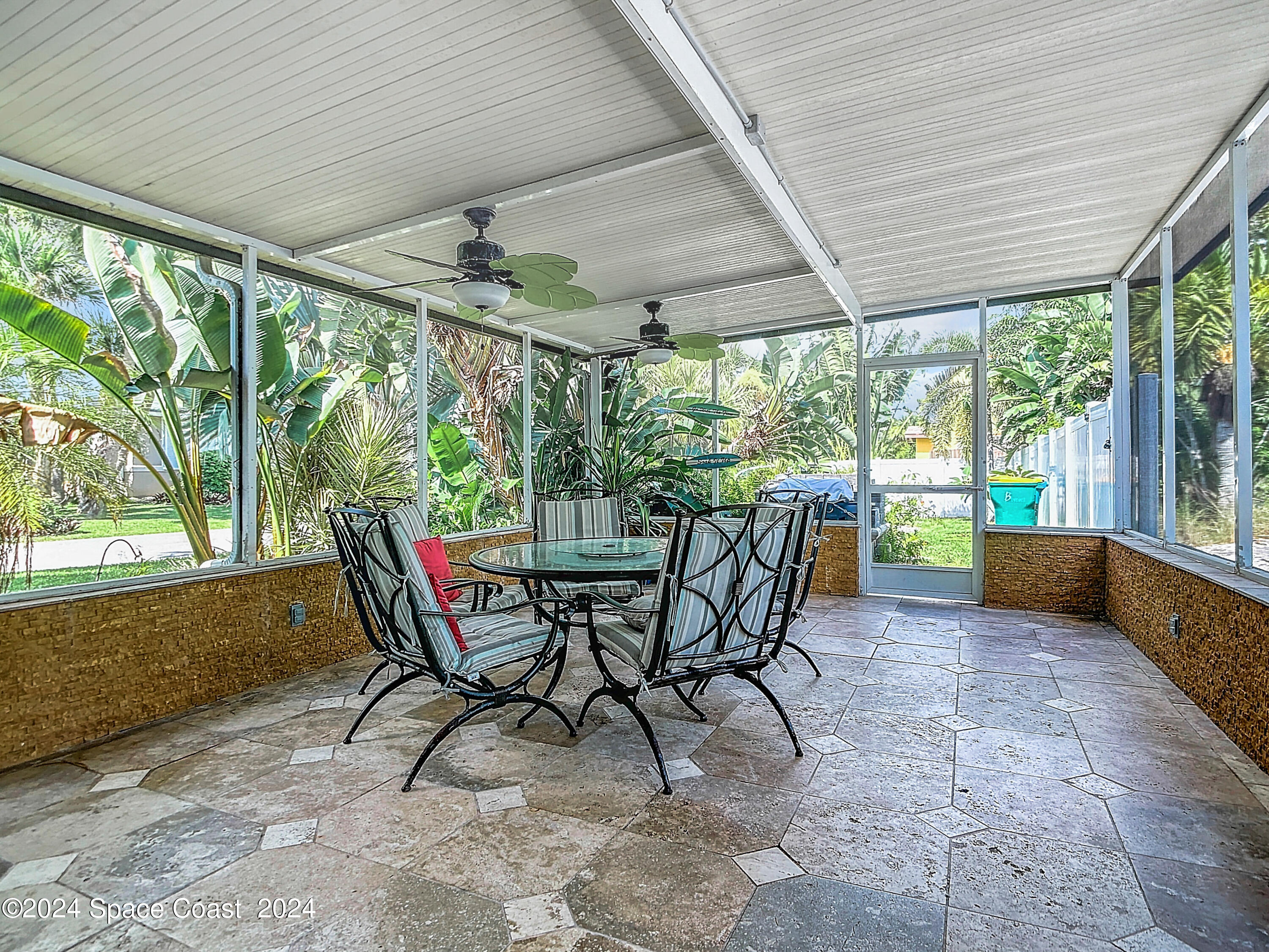 230 Rita Boulevard Melbourne Beach, FL 32951 - Photo 8 of 36 a view of a patio with table and chairs