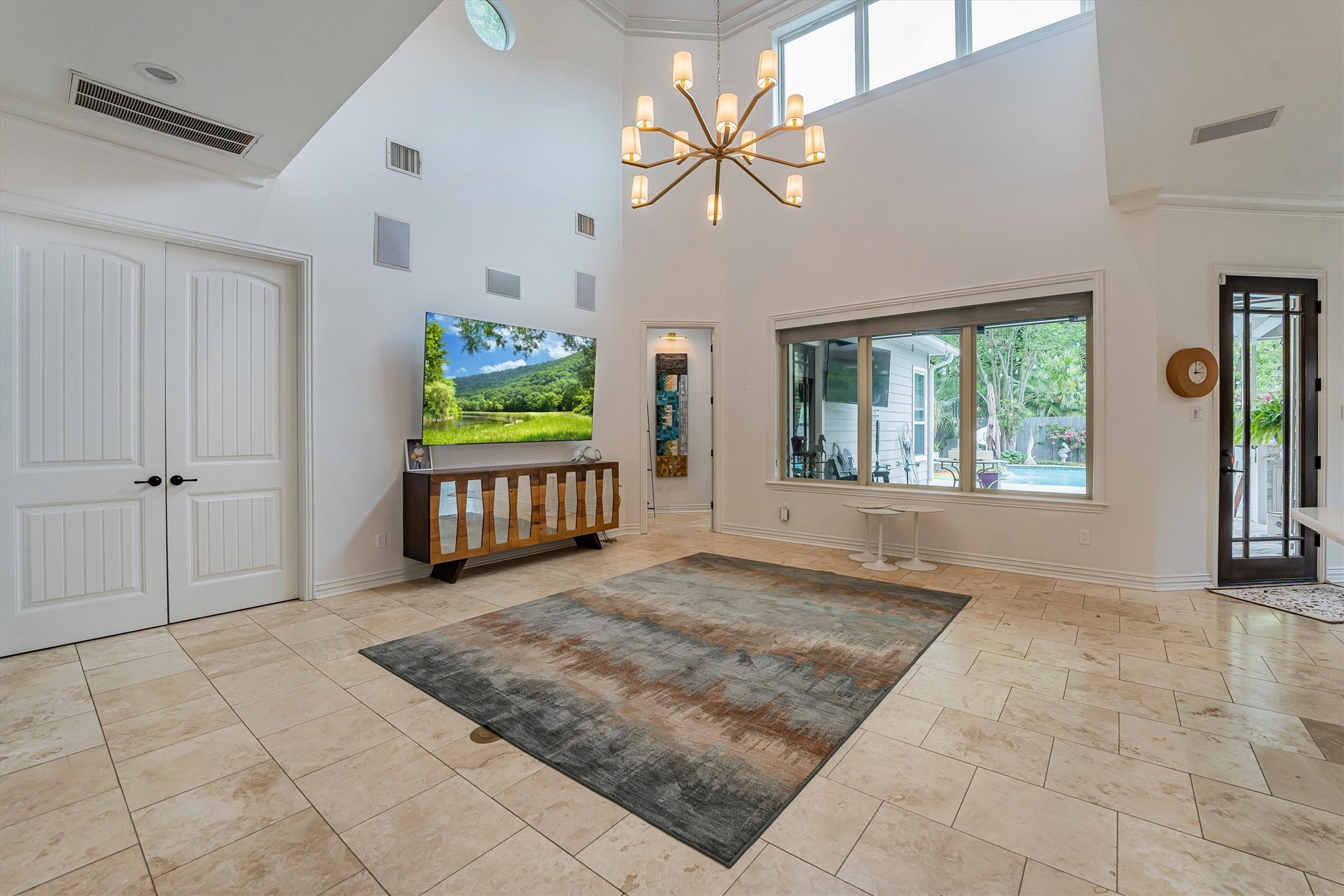 424 West 32nd Street Houston, TX 77018 - Photo 10 of 50 Note the light filled room, built-in speakers, the door way to right of TV to the owners wing. The double doors to the left of TV, the current exercise room with option for media room.