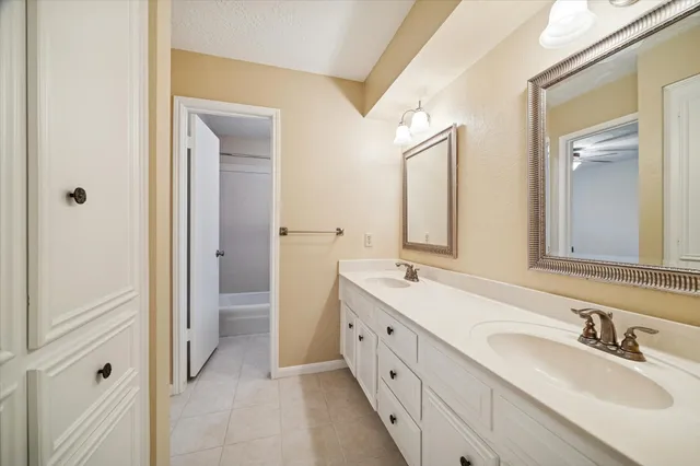 a bathroom with a granite countertop sink mirror and a toilet