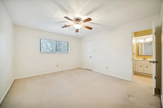 a view of an empty room with a ceiling fan