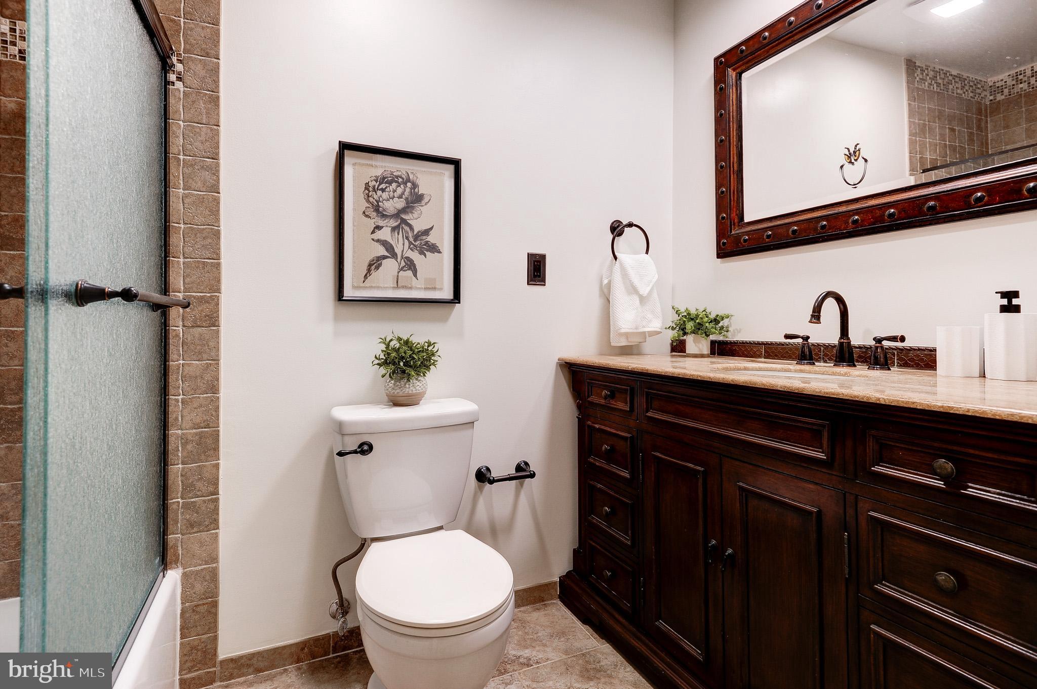 10116 Evans Ford Road Manassas, VA 20111 - Photo 25 of 63 a bathroom with a toilet a sink and mirror