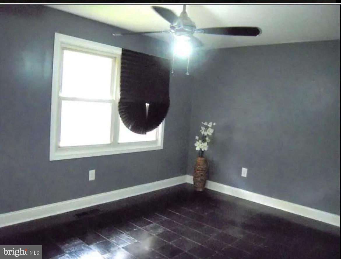 3 Strabane Court Parkville, MD 21234 - Photo 11 of 12 an empty room with wooden floor and windows
