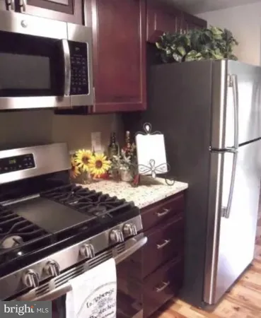 a stove top oven sitting inside of a kitchen