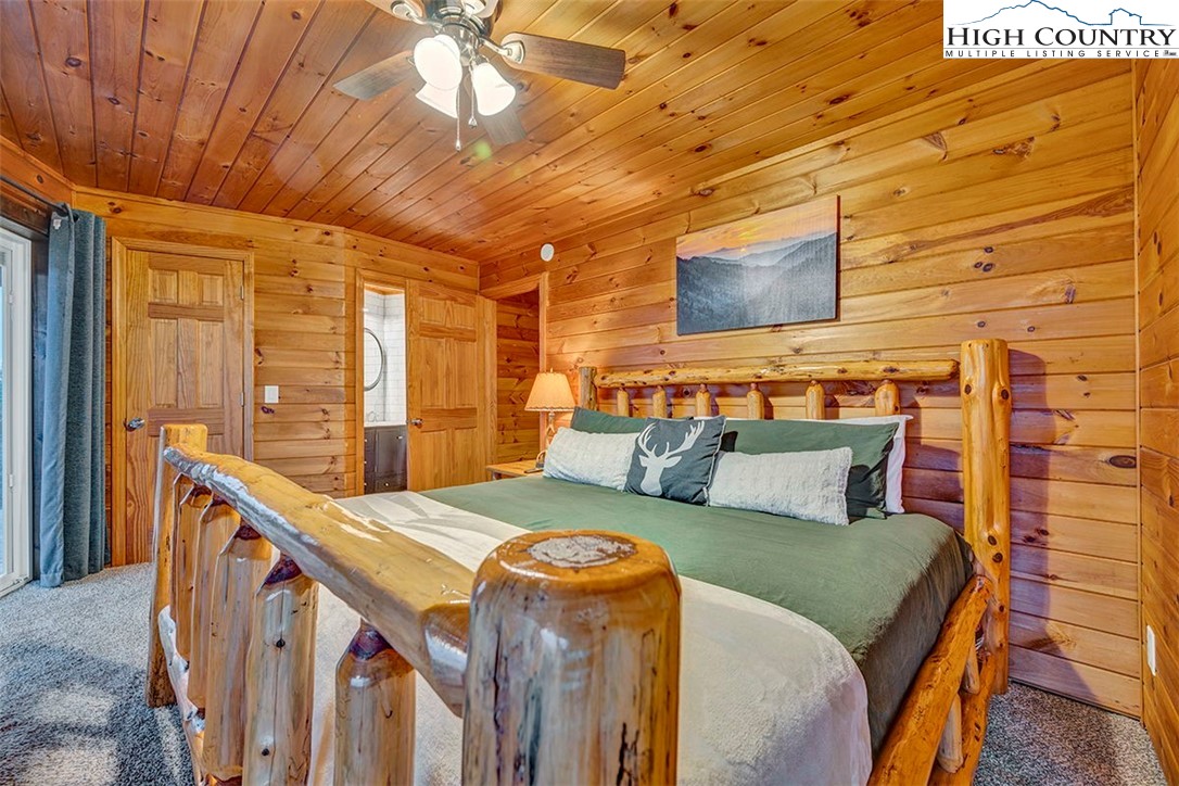 127 Skiloft Road Beech Mountain, NC 28604 - Photo 12 of 42 a bedroom with a bed and a night stand