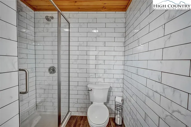 a bathroom with a toilet and a shower
