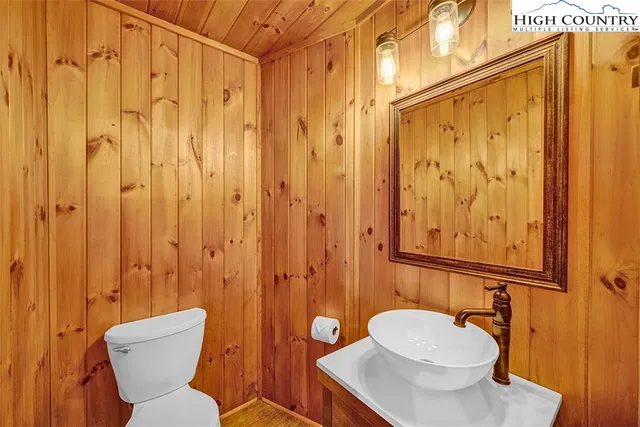 a bathroom with a toilet a sink and shower curtain