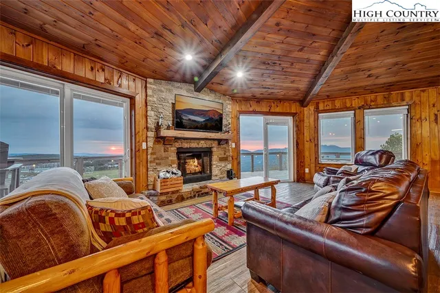 a living room with furniture fireplace and flat screen tv
