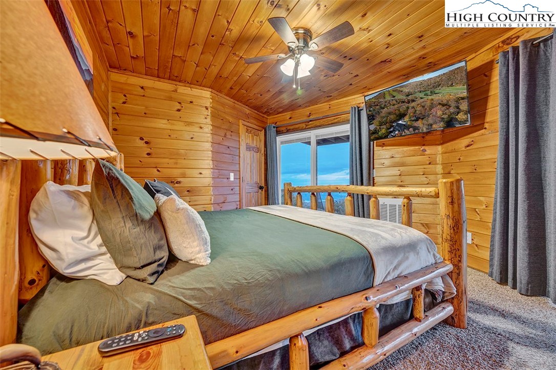 127 Skiloft Road Beech Mountain, NC 28604 - Photo 9 of 42 a bed sitting in a bedroom next to a window