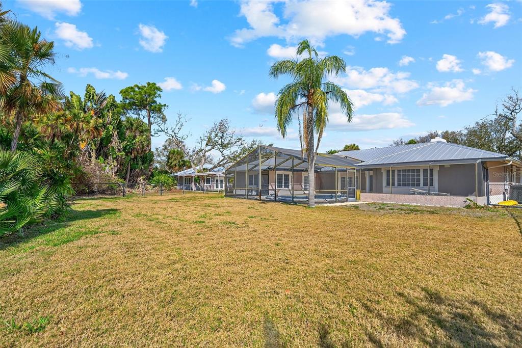 7108 Midnight Pass Road Sarasota, FL 34242 - Photo 55 of 83 a front view of a house with a garden