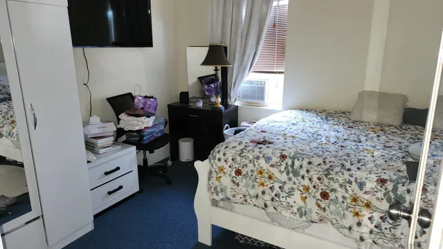 a bedroom with a bed and a window