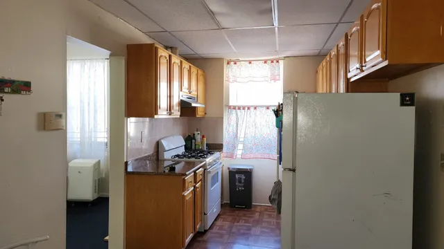 a kitchen with stainless steel appliances a refrigerator sink and cabinets