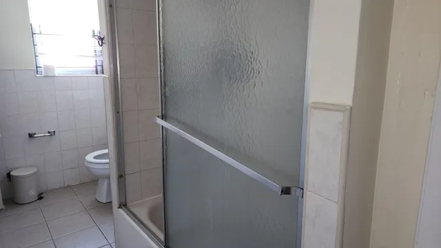 a bathroom with a toilet and a shower