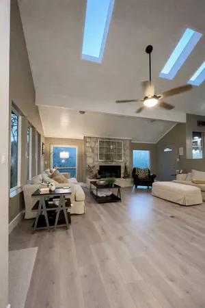 a living room with furniture and a chandelier
