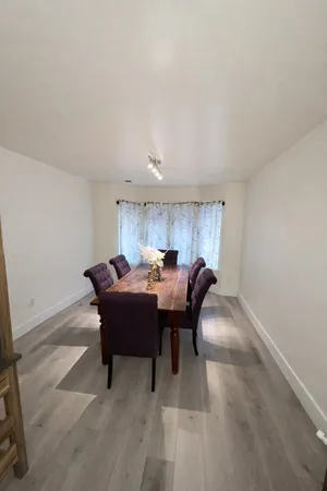 a view of a dining room with furniture and a rug