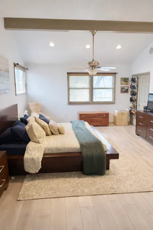 a bedroom with a bed couch and window
