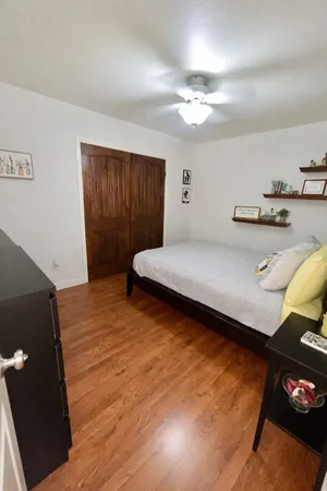 a bedroom with a bed and a night stand