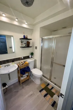 a bathroom with a sink toilet and shower