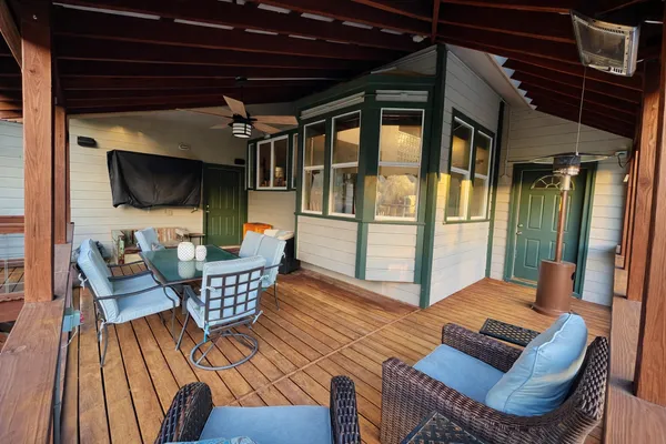 a outdoor living space with furniture and a flat screen tv