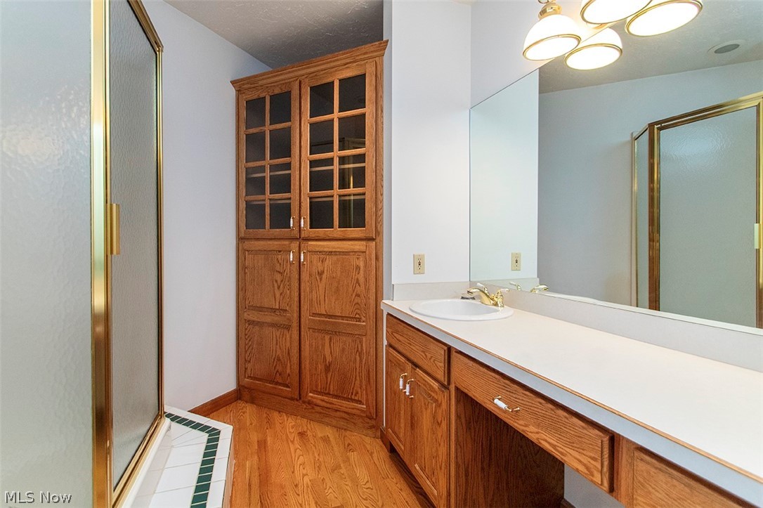 1871 Mattingly Road Hinckley, OH 44233 - Photo 29 of 50 Full bath with a stall shower, vanity, and light wood-type flooring