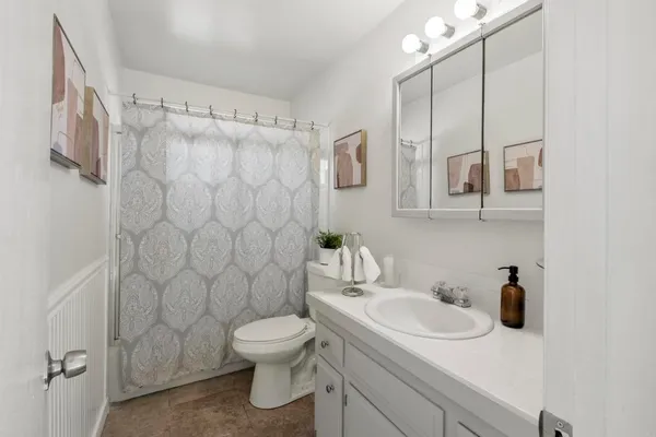 a bathroom with a sink toilet and shower