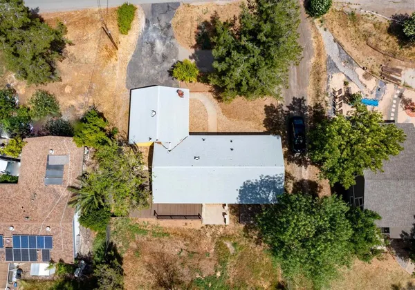 a front view of a house with a tree