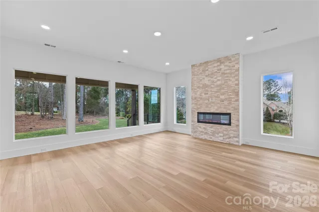 a kitchen with stainless steel appliances granite countertop a sink a stove and a refrigerator