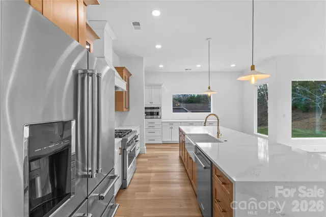 a bedroom with a bed a couch and a chandelier