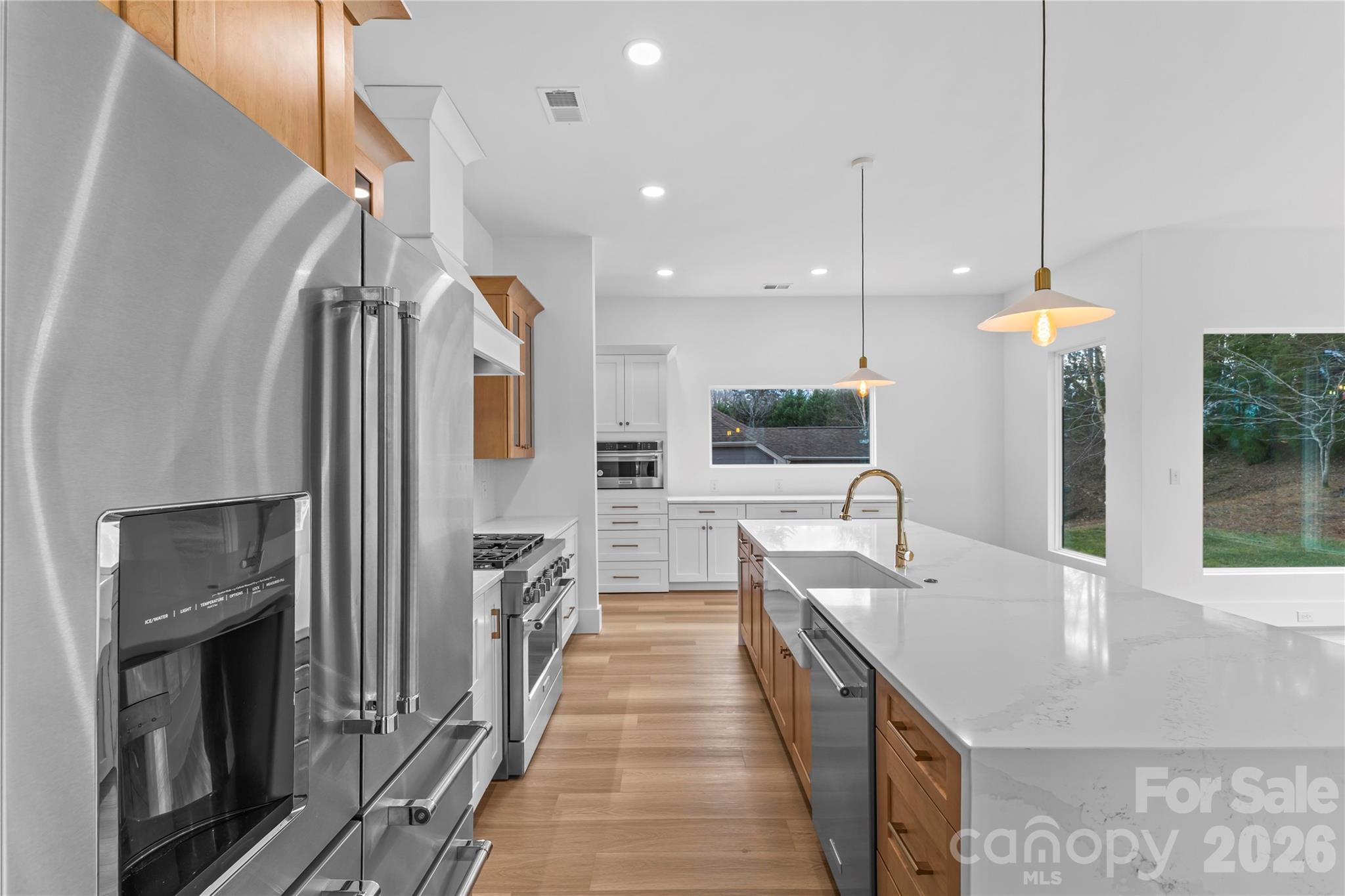 7362 Hemlock Court Denver, NC 28037 - Photo 15 of 46 a dining hall with stainless steel appliances granite countertop a sink a oven and a refrigerator with wooden floor