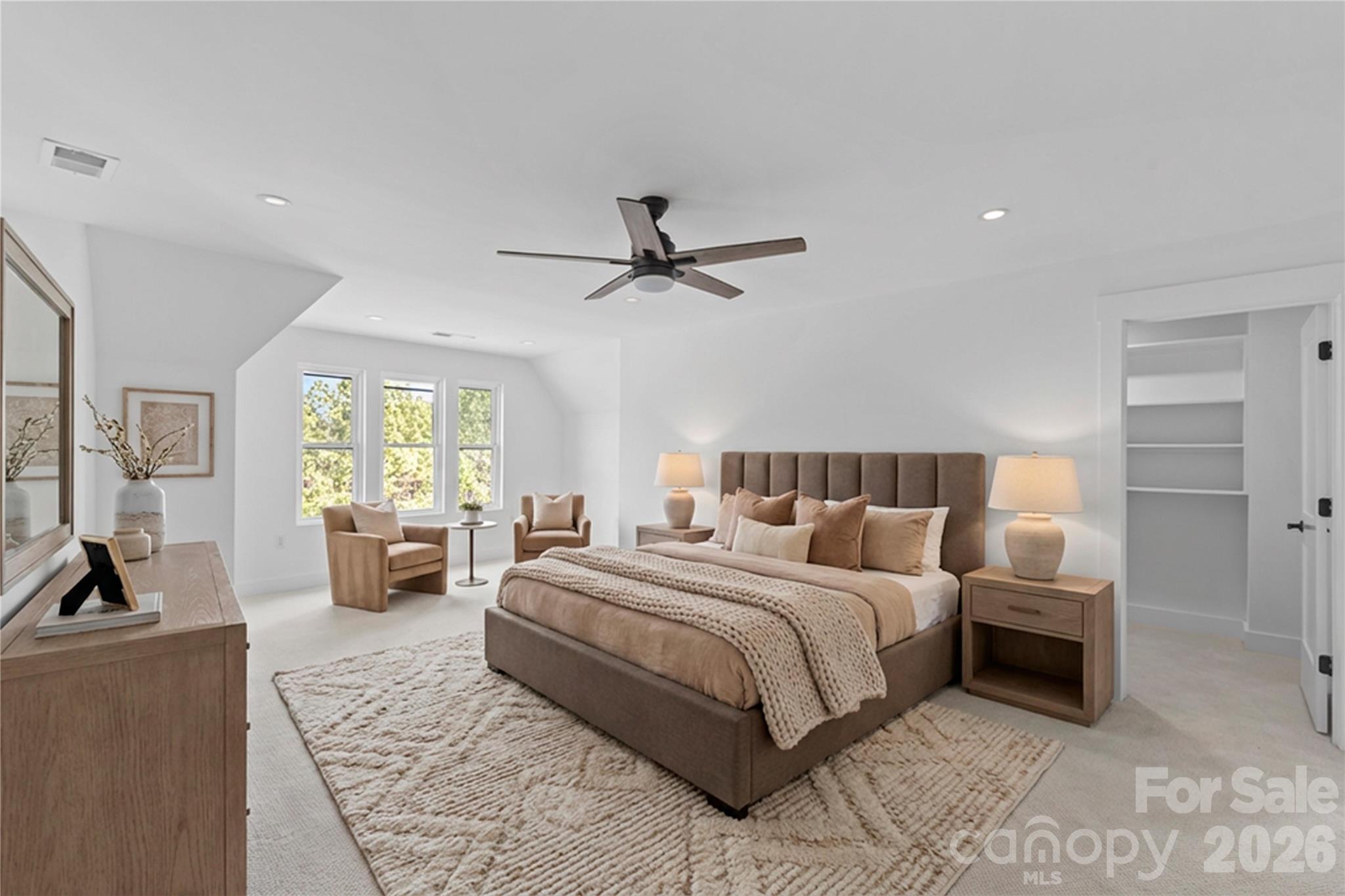 7362 Hemlock Court Denver, NC 28037 - Photo 21 of 46 a bedroom with a bed a couch and a chandelier