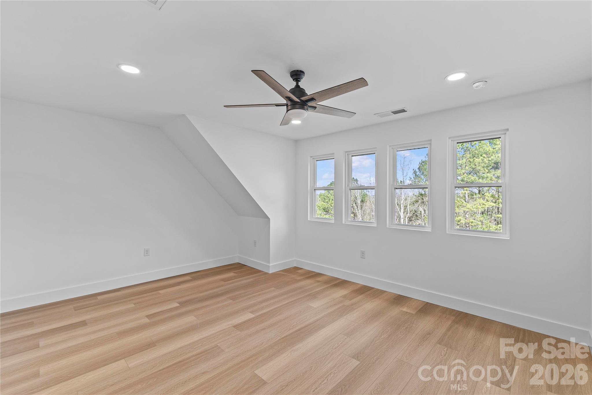 7362 Hemlock Court Denver, NC 28037 - Photo 32 of 46 an empty room with windows and fan