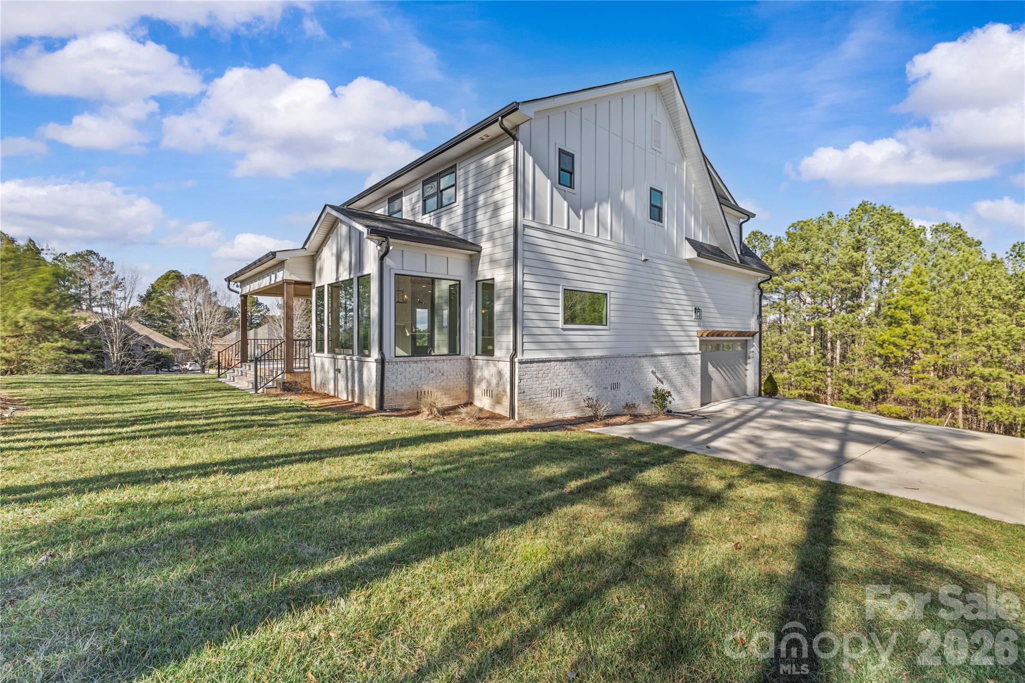 7362 Hemlock Court Denver, NC 28037 - Photo 41 of 46 a view of a white house with a big yard and large trees