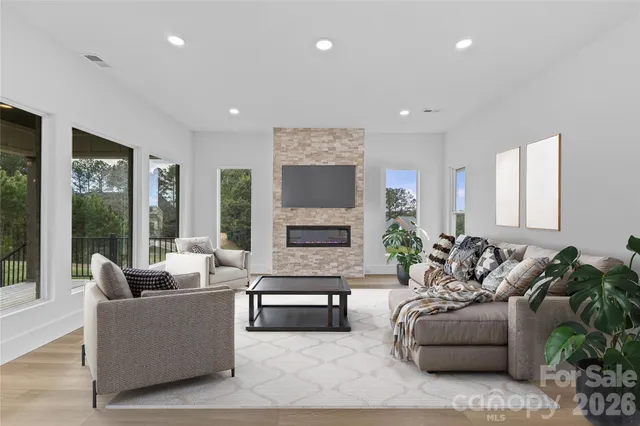 a view of an empty room with a fireplace and a window